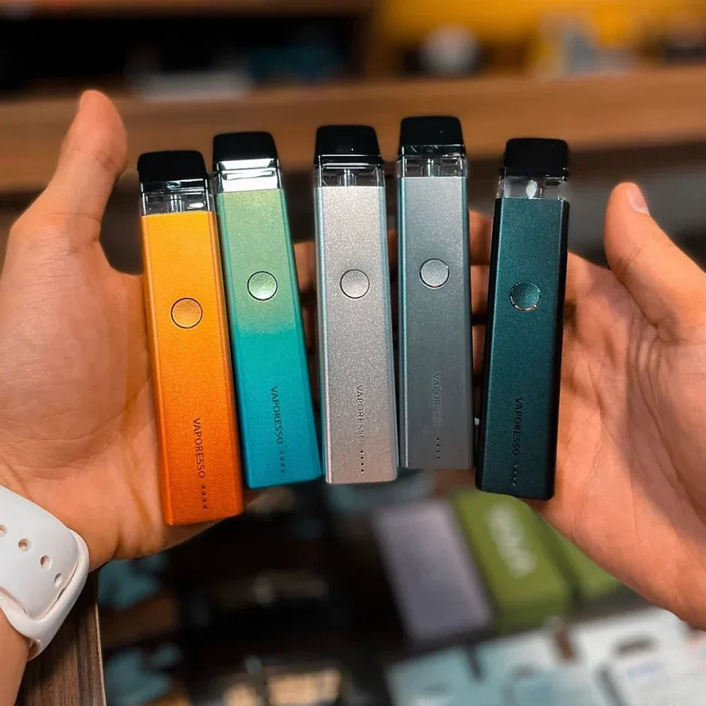 Five Vaporesso XROS 2 Pod Systems in assorted colors held in hand, showcasing variety in finishes and 1000mAh battery capacity.