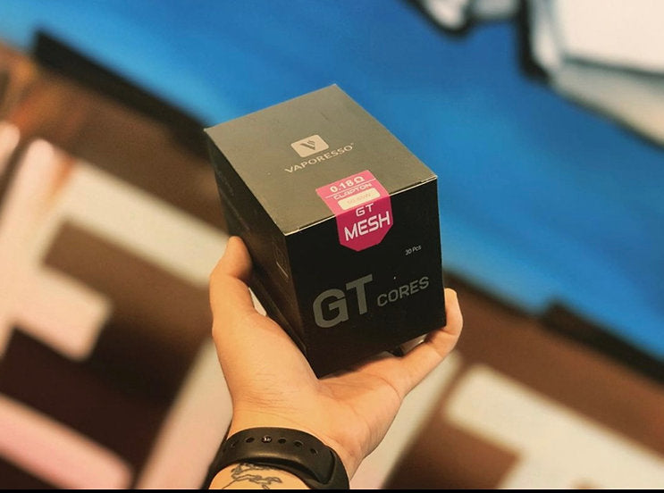 Hand holding Vaporesso GT Mesh Core Coils box - Optimal Performance, ideal for flavor-rich vaping with GT Meshed coil technology.