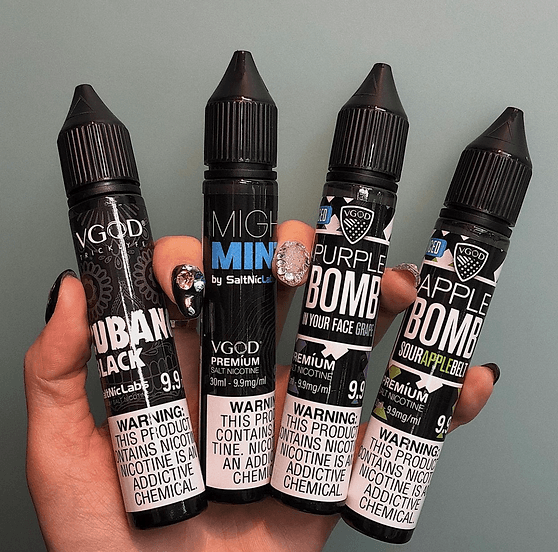 Assorted VGOD SaltNic E-Juice bottles including Cubano, Mighty Mint, Purple Bomb, and Apple Bomb. Variety pack for diverse flavor experiences.