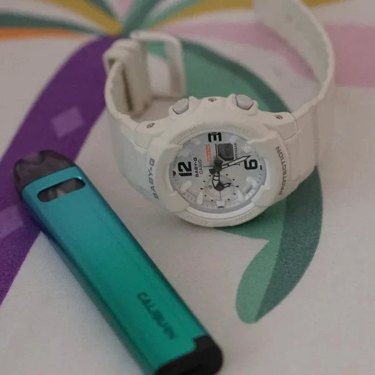 Uwell Caliburn A2S Pod System - 520mAh, 2mL pod next to a white G-Shock watch, highlighting its portable size and stylish appearance.