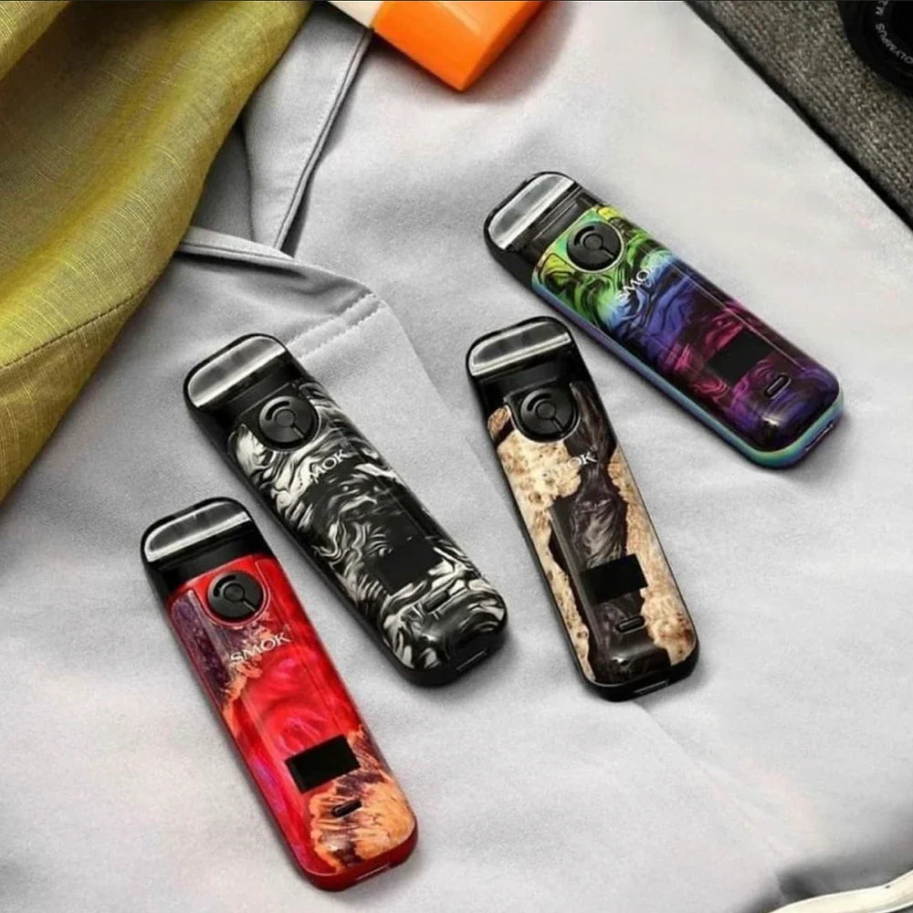 SMOK NOVO 4 Pod Kits - 25W in four artistic swirl finishes laid on fabric, emphasizing fashionable design and portability for everyday use.