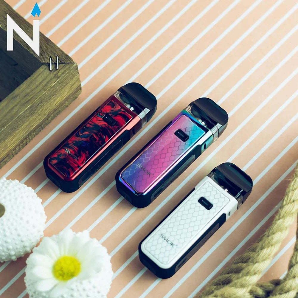 Three SMOK NORD X Pod Systems in red, rainbow, and white finishes on striped surface, highlighting stylish compact vape options.