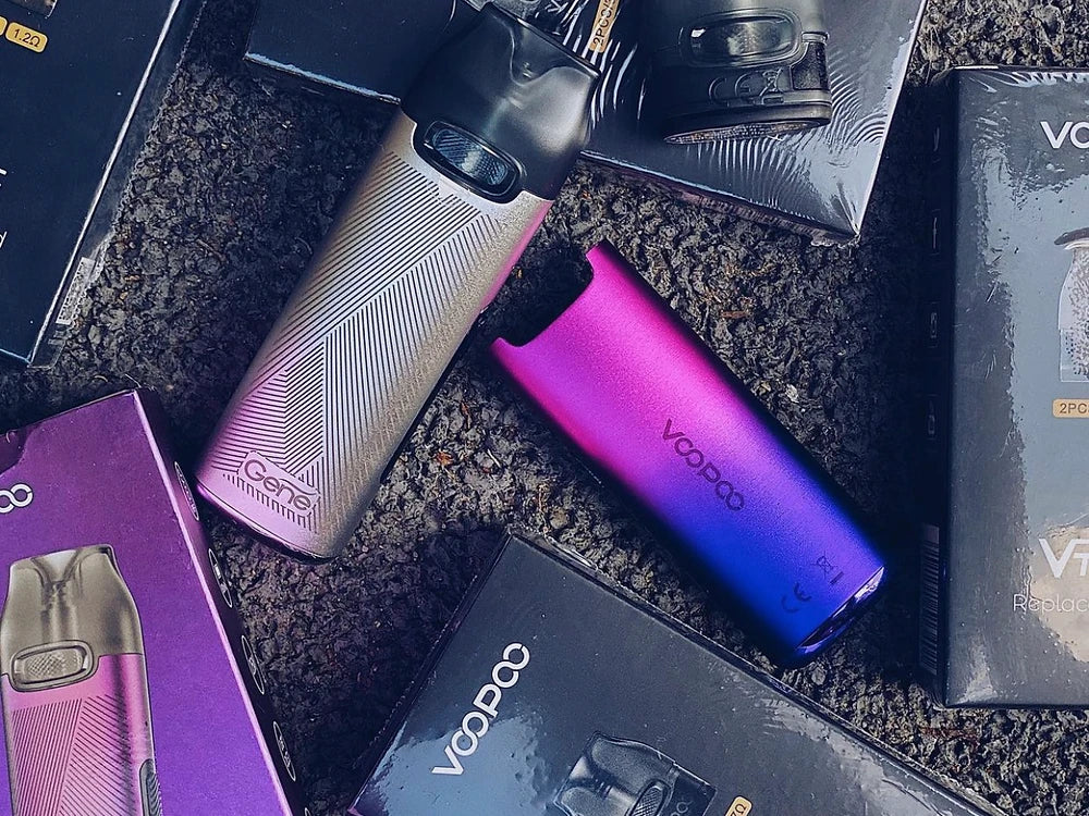 Multiple VOOPOO V Thru Pro Pod Systems in gradient colors with packaging, emphasizing product variety and retail-ready presentation.