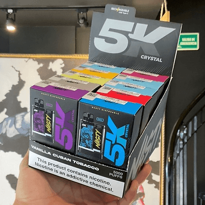Display box of Nasty 5K Crystal Vape - 5000 Puffs Disposable Device in assorted flavors like Vanilla Cuban Tobacco. Features 5% nicotine and 13ml e-liquid.