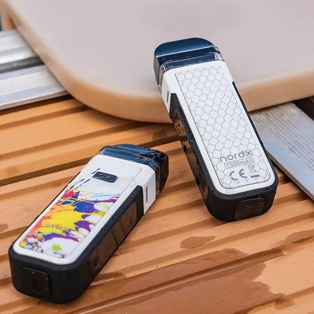 Two white SMOK NORD X Pod Systems with colorful and honeycomb designs on wooden surface, showcasing stylish and durable vape devices.