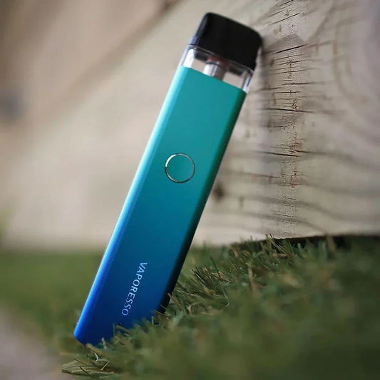 Vaporesso XROS 2 Pod System 16W in gradient blue leaning on wood, showcasing sleek design and compact build for portable vaping.