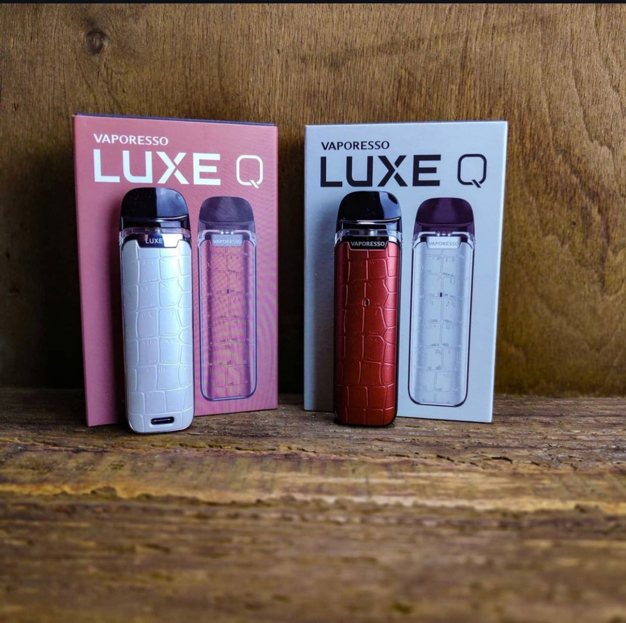 Vaporesso Luxe Q Pod Systems in white and red with matching boxes, featuring 2mL capacity and stylish anti-slip texture for portable vaping.