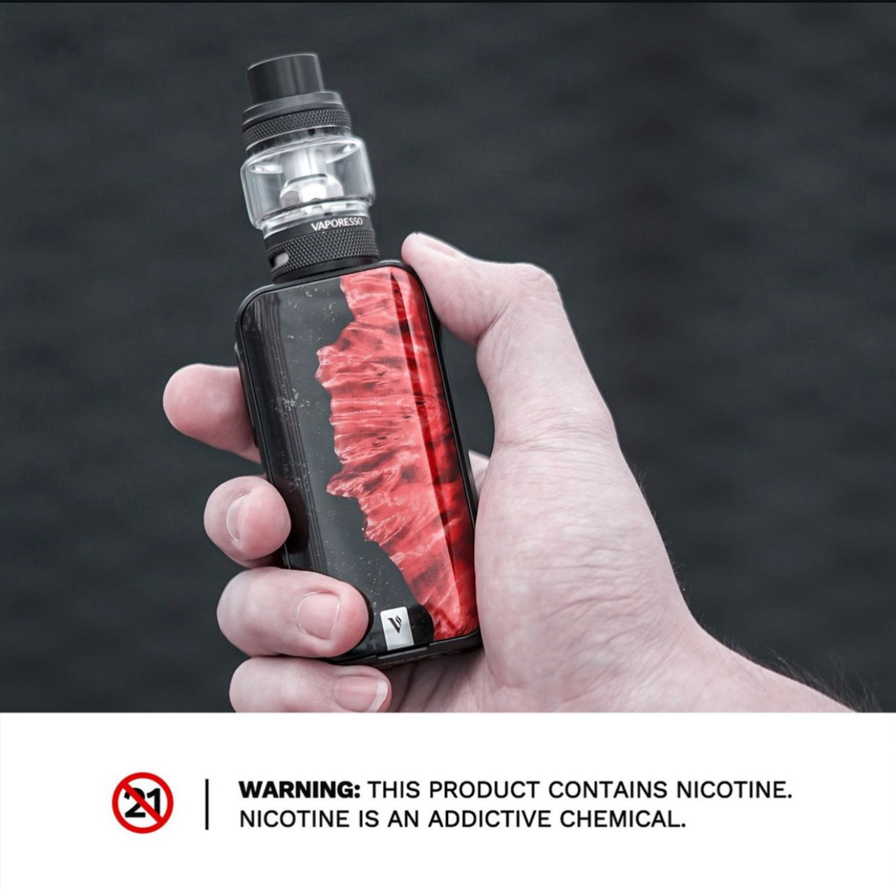 Hand holding Vaporesso Luxe 2 Starter Kit - 220W Dual Battery Vape with red abstract panel, showcasing ergonomic design and compact size.