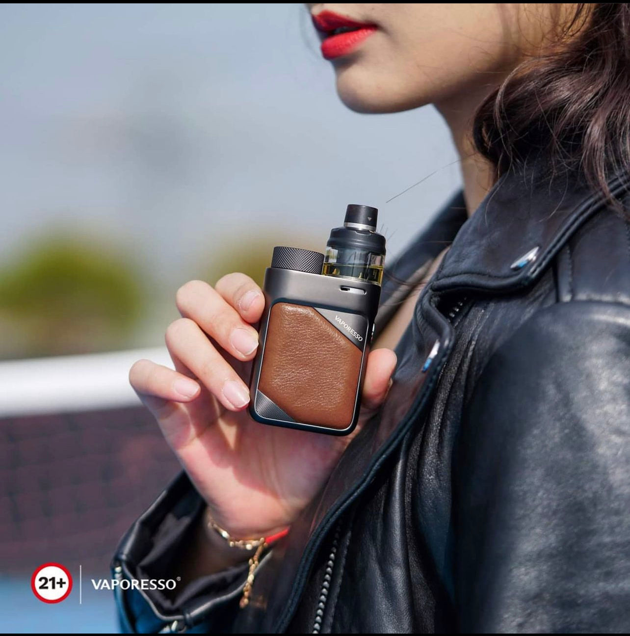 Woman holding Vaporesso SWAG PX80 Pod Mod Kit - 80W, 4mL with brown leather grip, showcasing portable vaping device for adult users.
