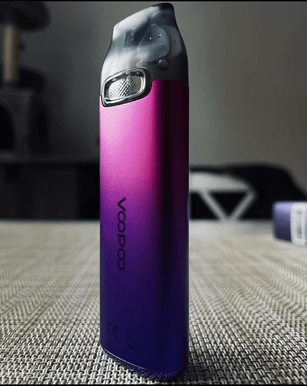 Purple gradient VOOPOO V Thru Pro Pod System 25W standing upright on a table, showcasing its stylish finish and ergonomic build.