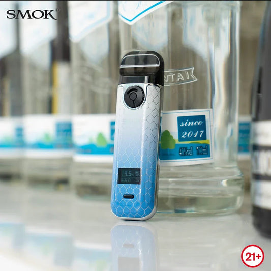 SMOK NOVO 4 Pod Kit - 25W in blue gradient finish displayed upright with OLED screen on, placed against clear bottles for a sleek look.