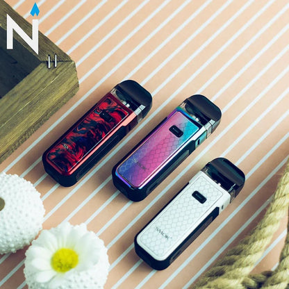 Three SMOK NORD X Pod Systems in red, rainbow, and white finishes on striped surface, highlighting stylish compact vape options.